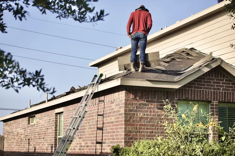 Professional roofer working on a residential roof in Newbury Park